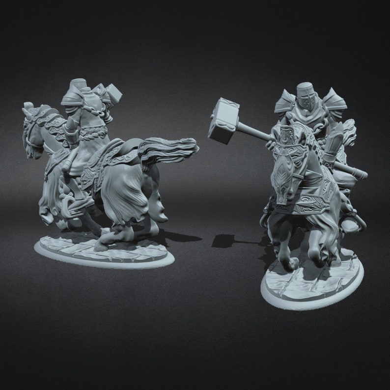 May include: A pair of grey, detailed miniature figurines of knights on horseback. One knight is holding a large hammer, while the other is holding a sword. Both knights are wearing armour and helmets.