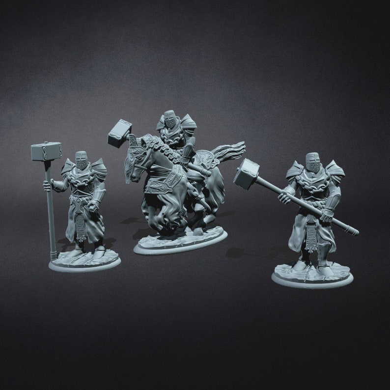 May include: Three miniature figures of knights, one on horseback, all holding large hammers. The figures are painted in a grey colour and are posed in a dynamic action stance.