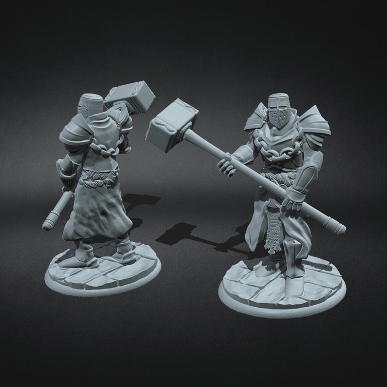 May include: Two grey painted miniature figures of knights wearing armour and holding a large hammer. The figures are standing on round bases.