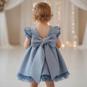 Elegant blue linen dress with tulle details, short and long sleeve options, ideal for special occasions and weddings.