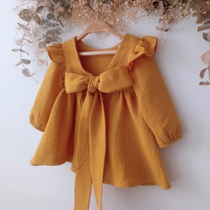 Muslin baby dress with long sleeves in cotton, Girls Muslin Dress With Ruffles, Mustard color cotton muslin dress for baby girl.