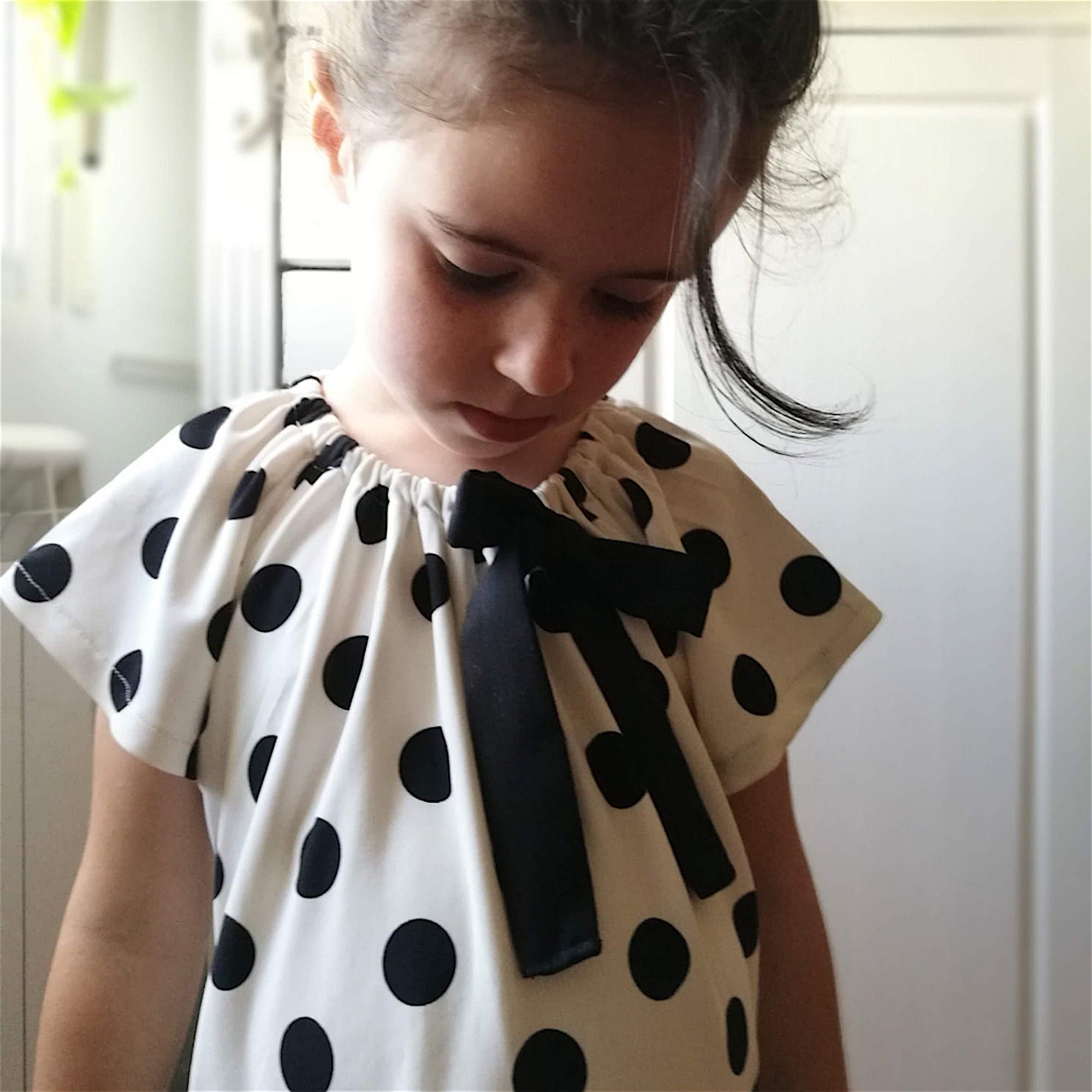 girls black and white polka dot shirt