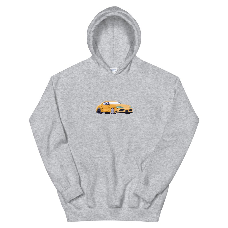 Pode incluir: Um moletom cinza com um carro amarelo bordado na frente. O carro &eacute; um carro esportivo com interior preto.