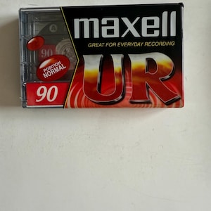 May include: A red and black Maxell UR 90 minute audio cassette tape. The cassette is labeled "Great for Everyday Recording".