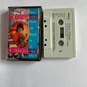 May include: A vintage cassette tape by Tracey Ullman, titled "You Broke My Heart in 17 Places." The cassette case has a colourful design with the album title and artist's name. The tape is a light grey colour.
