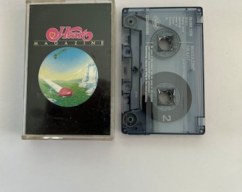 May include: A cassette tape of Heart's album "Magazine" with a black and white photo of a match and a red heart on the cover.