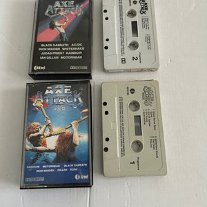 May include: Two black cassette tapes with the title "Axe Attack" and a list of bands including Black Sabbath, Iron Maiden, Whitesnake, Judas Priest, Rainbow, Ian Gillan, Motorhead, and Rush.