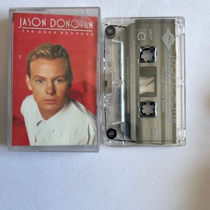 May include: A cassette tape with a clear plastic case. The cassette tape is labelled "JASON DONOVAN" and "TEN GOOD REASONS".