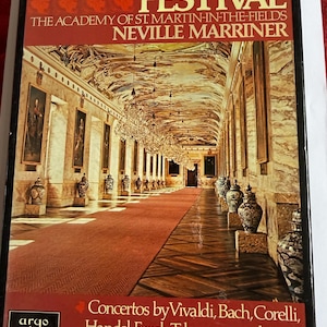 May include: A Baroque Festival album cover showing a grand hall with detailed architecture, chandeliers, and paintings. The cover displays the text "A Baroque Festival" and credits the Academy of St. Martin-in-the-Fields and Neville Marriner. The album features concertos by Vivaldi, Bach, Corelli, Handel, Fasch, Telemann, and Arne.