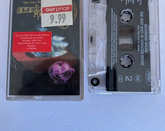 May include: A cassette tape of the album "The Very Best of Crowded House" by Recurring Dream. The cassette tape is in a clear plastic case with a black label. The label has the band's name, album title, and a copyright notice. The cassette tape is priced at $9.99.
