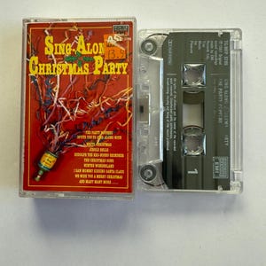 May include: A vintage cassette tape titled "Sing-Along Christmas Party" by The Party Poppers. The cassette case is red with colorful text and festive graphics. The clear cassette tape is visible next to the case.