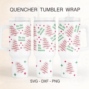 May include: White tumbler with a handle and a straw. The tumbler has a Christmas tree design with the text "Tis the season" repeated on the tumbler.