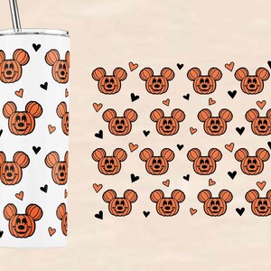 May include: A white stainless steel tumbler with a black straw. The tumbler has a repeating pattern of orange pumpkin Mickey Mouse heads and black hearts.