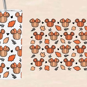 May include: A white tumbler with a straw features a pattern of orange pumpkins with bows and black leaves. The tumbler is surrounded by a white background.