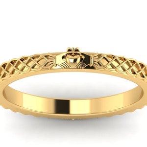 May include: A gold Celtic knot ring featuring a Claddagh design. The ring depicts a heart held by two hands, representing love, friendship, and loyalty.