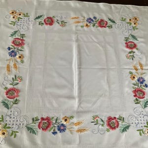Stunning hand embroidered small floral tablecloth.