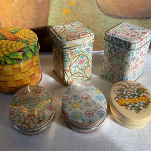 Six vintage decorative tins with soap.