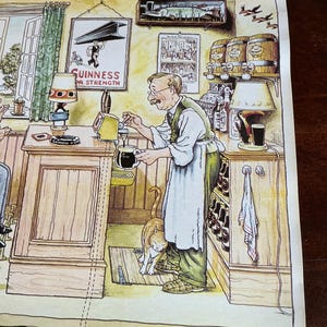 May include: Illustration of a pub scene with a man pouring a dark beer. The image features a cat, barrels, and a sign that reads "Guinness for Strength." The text "Gentle Art Of Making Guinness" is at the top.