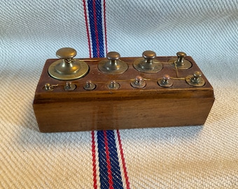 Antique french brass weights in their original wooden holder