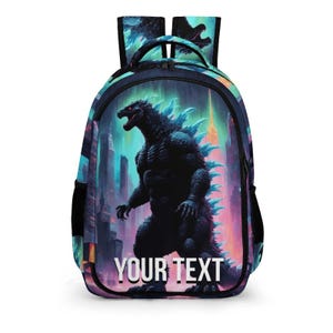 May include: A backpack featuring a Godzilla design with a cityscape backdrop. The backpack has a black base with a large graphic of Godzilla in front of a city skyline. The text "YOUR TEXT" is displayed at the bottom of the image.