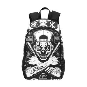 May include: A black and white backpack featuring a graphic print of a clown wearing a baseball cap with dollar signs in the eyes. The design includes crossed baseball bats, spider webs, and the text "Thug Life," "No Trespassing," and "Danger."