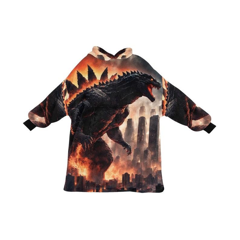 May include: A black and orange hooded sweatshirt featuring a Godzilla graphic. The design shows Godzilla in a city setting with flames and a fiery sky. The sleeves have black cuffs.