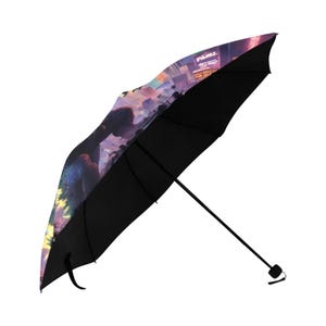 May include: A black and purple umbrella with a cityscape and a Godzilla-like creature printed on the canopy.