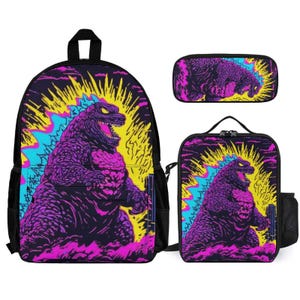 May include: A three-piece school set featuring a backpack, lunch bag, and pencil case. All three pieces feature a colourful graphic of a Godzilla-like monster with a yellow, pink, and blue colour scheme.