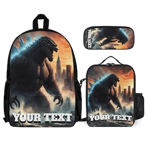 May include: A black backpack, pencil case, and lunch bag set featuring a Godzilla design against a cityscape backdrop. The set includes the text "YOUR TEXT" in a white, bold font. The design has orange and blue hues.