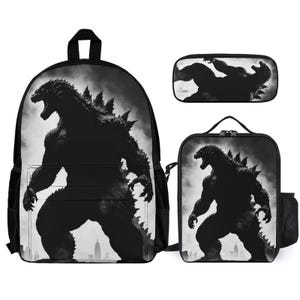 May include: A black backpack, lunch bag, and pencil case featuring a black and white Godzilla silhouette. The backpack has a large zippered pocket on the front and adjustable straps. The lunch bag has a zippered closure and a handle. The pencil case has a zippered closure.