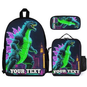 May include: A black backpack, lunch bag, and pencil case set featuring a neon green and purple dinosaur graphic against a city skyline. Each item displays the text YOUR TEXT in white block letters at the bottom or side of the design.