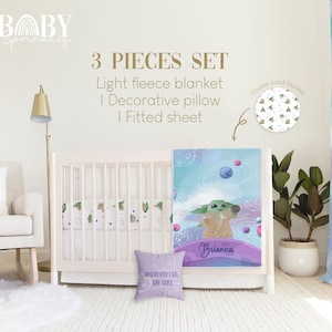 May include: A 3-piece baby bedding set featuring a light blue and purple fleece blanket with a galaxy and planets design, a decorative pillow with the text "WHEREVER I GO, SHE GOES", and a fitted sheet with a green and white pattern. The blanket has the name "Brianna" written on it.