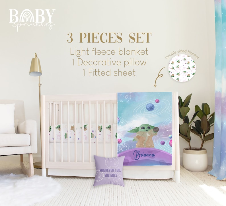 May include: A 3-piece baby bedding set featuring a light blue and purple fleece blanket with a galaxy and planets design, a decorative pillow with the text "WHEREVER I GO, SHE GOES", and a fitted sheet with a green and white pattern. The blanket has the name "Brianna" written on it.