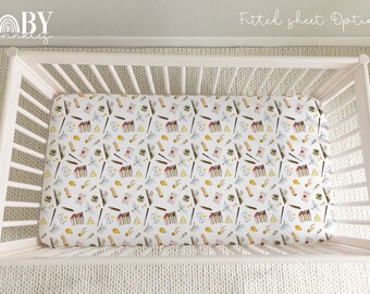 May include: White crib with a fitted sheet featuring a white background with a repeating pattern of yellow and brown Harry Potter themed illustrations. The text "Fitted sheet Option |" is visible in the top right corner of the image.
