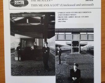 May include: Black and white album cover featuring The Beatles. The album title is "THIS MEANS A LOT!" with text indicating unreleased studio recordings and stereo mixes from the Abbey Road Studio Archives, 1963-1966. The cover includes photos of the band.