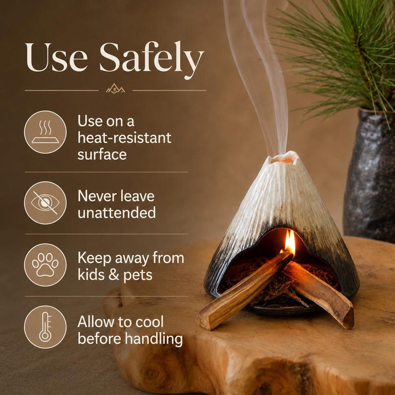 May include: A ceramic incense burner shaped like a volcano, with a lit incense stick inside, emitting smoke. The burner is black and white, sitting on a wooden surface. Text on the image reads "Use Safely" with safety instructions.