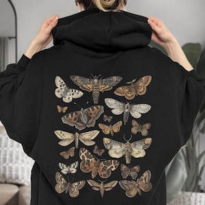 May include: Black hooded sweatshirt featuring a vintage illustration of assorted butterflies and moths in shades of brown, white, and black.