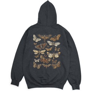 May include: A dark grey hooded sweatshirt featuring a print of assorted butterflies and moths in shades of brown, beige, and white.