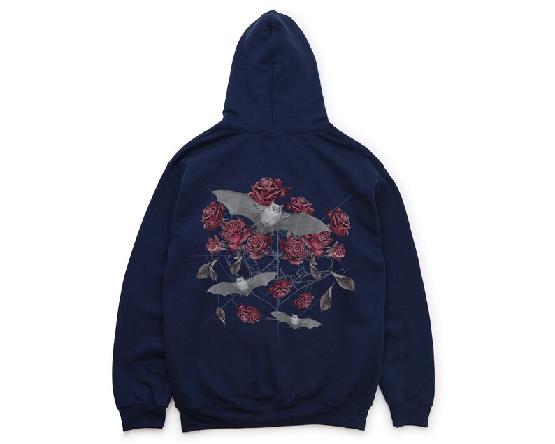 May include: Navy blue hoodie featuring a graphic of bats, red roses, and a spiderweb design. The hooded sweatshirt has a drawstring and a kangaroo pocket. The back of the hoodie displays the graphic.