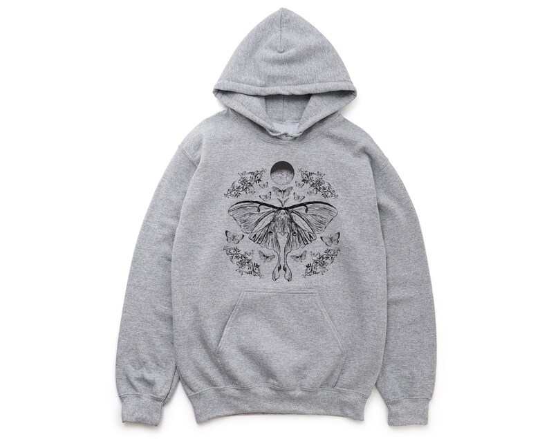 May include: A grey hooded sweatshirt with a black and white graphic print of a moth with a moon and floral accents.