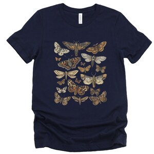 May include: A navy blue t-shirt with a print of various moths in shades of brown, white, and black.