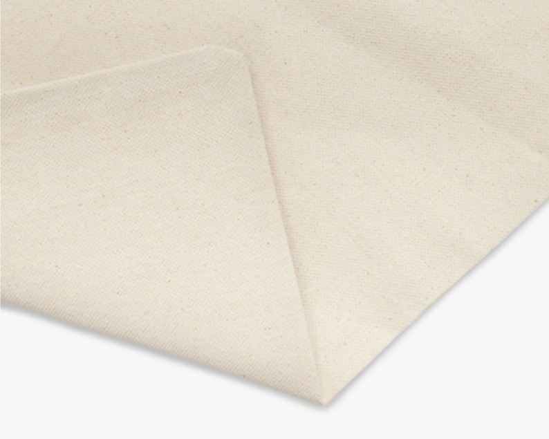 May include: Close-up of a plain, off-white fabric with a slightly textured surface.