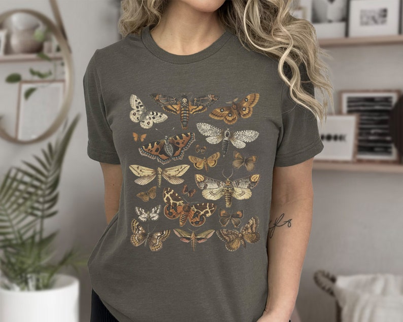 May include: A dark gray t-shirt with a vintage illustration of various butterflies and moths in shades of brown, white, and black.