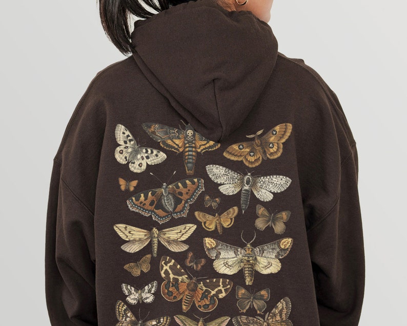 May include: A brown hooded sweatshirt featuring a print of assorted butterflies and moths in shades of brown, white, and black.