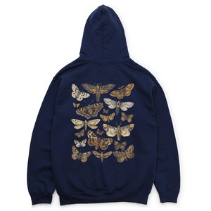 May include: A navy blue hooded sweatshirt with a graphic print of various moths and butterflies on the back.
