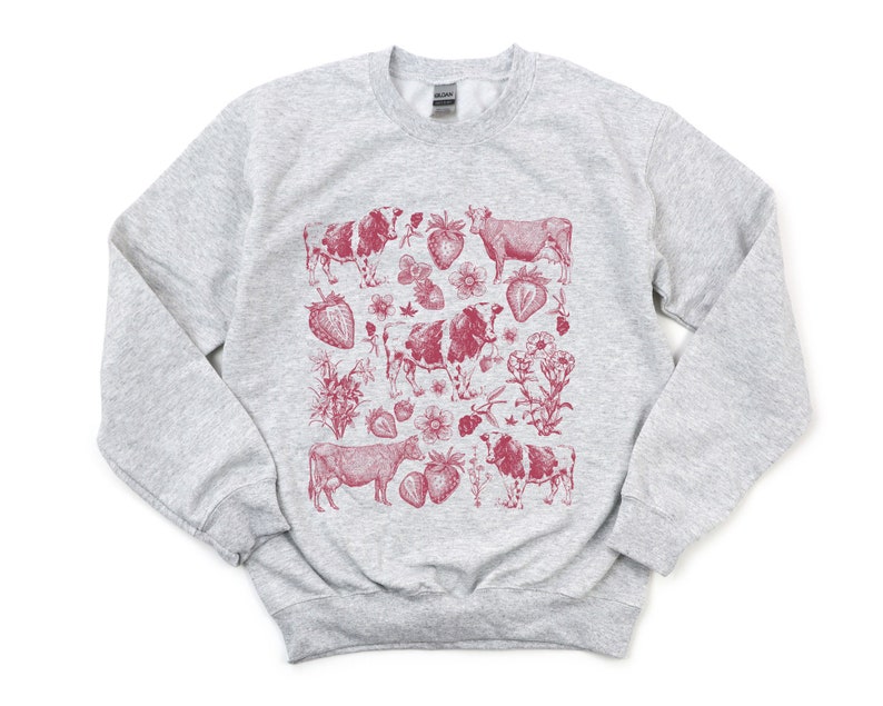May include: A gray sweatshirt with a red print of cows and strawberries. The print is a vintage style illustration.