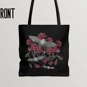 May include: Black tote bag with a design of bats and red roses on a spiderweb. The design is in a circular shape.