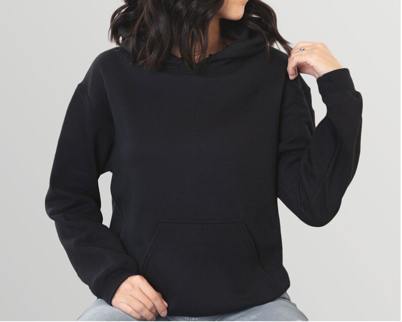 May include: A black hoodie with a kangaroo pocket and a drawstring hood. The long-sleeved sweatshirt is made of a soft material and is a solid color.
