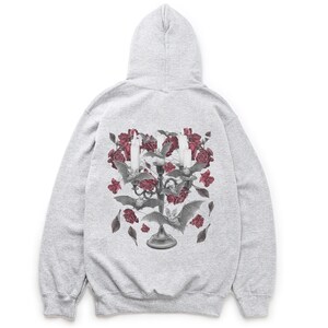 May include: A gray hooded sweatshirt with a graphic print of a candelabra with red roses and bats. The candelabra is surrounded by a cluster of red roses and bats.