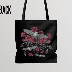 May include: Black tote bag with a design of bats flying around red roses and a spider web. The design is in a gray and white color scheme.
